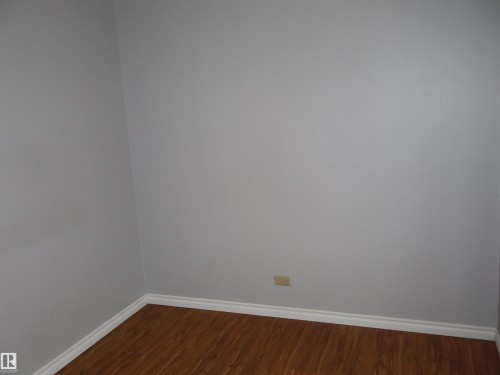 Spare room featuring baseboards and dark wood finished floors - 5109 55 Street, Barrhead, AB - Indoor Photo Showing Other Room