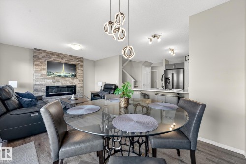 9040 Cooper Link, Edmonton, AB - Indoor Photo Showing Dining Room With Fireplace