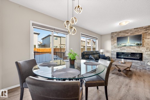 9040 Cooper Link, Edmonton, AB - Indoor Photo Showing Dining Room With Fireplace
