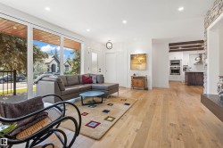 Living room featuring light wood finished floors and recessed lighting - 