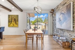 Dining room with suspended lighting, light wood-style floors, and beamed ceiling - 