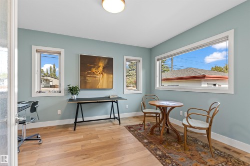 Living area with light wood finished floors and a desk - 14412 80 Avenue Nw, Edmonton, AB - Indoor Photo Showing Office