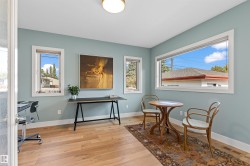 Living area with light wood finished floors and a desk - 