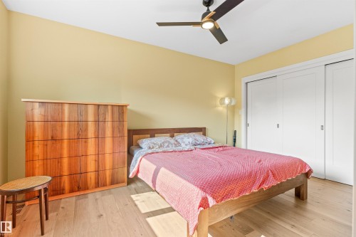 Bedroom featuring wood finished floors, a closet, and a ceiling fan - 14412 80 Avenue Nw, Edmonton, AB - Indoor Photo Showing Bedroom