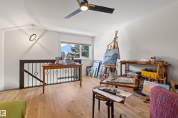 Home office with hardwood / wood-style flooring and ceiling fan - 