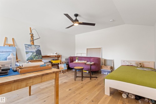 Bedroom with light wood finished floors, a ceiling fan, and vaulted ceiling - 14412 80 Avenue Nw, Edmonton, AB - Indoor Photo Showing Bedroom