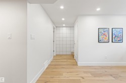 Hall with light wood-style floors and recessed lighting - 