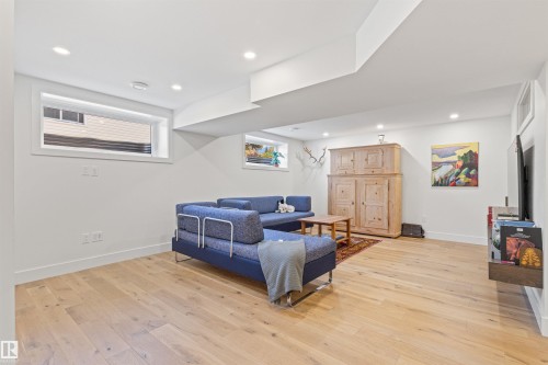 Living room with light wood-style floors and recessed lighting - 14412 80 Avenue Nw, Edmonton, AB - Indoor