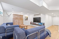 Living area featuring light wood finished floors and recessed lighting - 