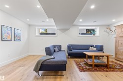 Living area with light wood-style floors and recessed lighting - 