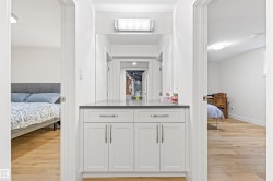 Ensuite bathroom featuring light wood-style flooring and vanity - 