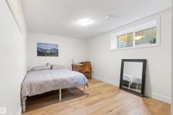 Bedroom with light wood finished floors and baseboards - 