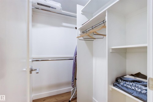 Walk in closet featuring light wood finished floors - 14412 80 Avenue Nw, Edmonton, AB - Indoor