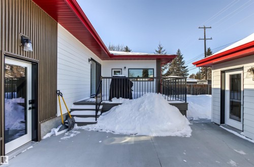 Snow covered patio featuring a wooden deck - 14412 80 Avenue Nw, Edmonton, AB - Outdoor With Exterior