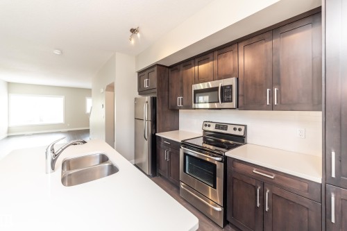 22 2560 Pegasus Boulevard, Edmonton, AB - Indoor Photo Showing Kitchen With Stainless Steel Kitchen With Double Sink