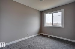 Spare room featuring baseboards and carpet - 