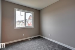 Empty room featuring baseboards and carpet flooring - 