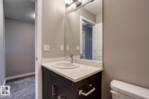 Half bathroom featuring vanity and carpet - 78 13139 205 Street Nw, Edmonton, AB - Indoor Photo Showing Bathroom