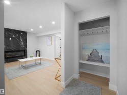 Mudroom with light wood-type flooring, a fireplace, and recessed lighting - 
