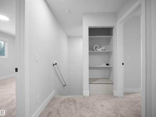 Hallway with light colored carpet and an upstairs landing - 9409 173 Street, Edmonton, AB - Indoor Photo Showing Other Room