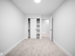 Unfurnished bedroom with light carpet and a closet - 