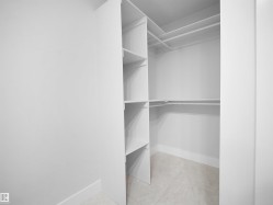 Walk in closet featuring light tile patterned floors - 