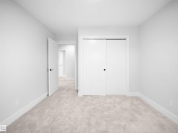 Unfurnished bedroom featuring light colored carpet and a closet - 