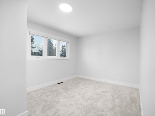 Spare room featuring light carpet and baseboards - 9409 173 Street, Edmonton, AB - Indoor Photo Showing Other Room