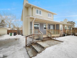 View of front facade featuring a chimney and covered porch - 