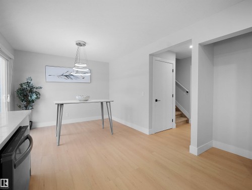 Dining room featuring light wood-type flooring and stairway - 9409 173 Street, Edmonton, AB - Indoor Photo Showing Other Room