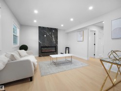 Living room with a premium fireplace, light wood-style floors, and recessed lighting - 