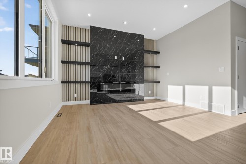 181 Edgewater Circle, Leduc, AB - Indoor Photo Showing Other Room With Fireplace