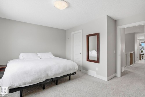 Bedroom featuring carpet flooring and a textured ceiling - 1915 77 Street Sw, Edmonton, AB - Indoor Photo Showing Bedroom