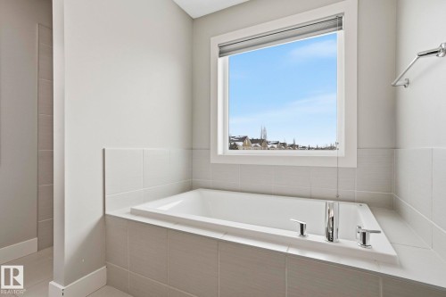 Full bathroom featuring a bath - 1915 77 Street Sw, Edmonton, AB - Indoor Photo Showing Bathroom
