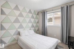 Bedroom with carpet floors, a textured ceiling, and an accent wall - 