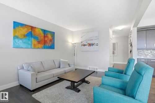 Living area with dark wood-type flooring - 1915 77 Street Sw, Edmonton, AB - Indoor Photo Showing Living Room