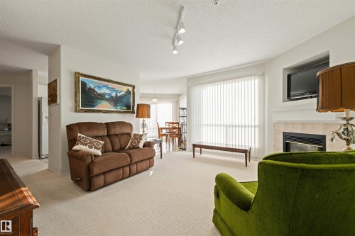 406 182 Haddow Close, Edmonton, AB - Indoor Photo Showing Living Room With Fireplace