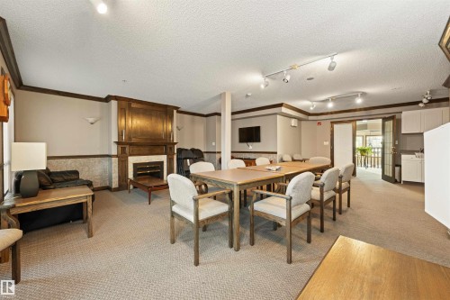 406 182 Haddow Close, Edmonton, AB - Indoor Photo Showing Other Room With Fireplace