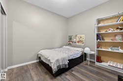 Bedroom featuring dark wood finished floors and a textured ceiling - 