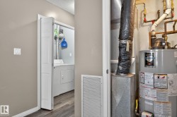 Utility room featuring water heater and washer / clothes dryer - 