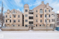 Snow covered property with a view of apartment building / complex - 