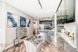 Dining area with track lighting and light wood-style flooring - 