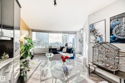 Living room featuring a baseboard heating unit, a wall mounted mini split, and a view of city - 