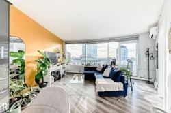 Living room featuring light wood-style floors, baseboard heating, and a mini split for heating / cooling - 