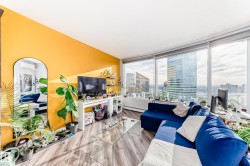 Living room featuring wood finished floors, baseboard heating, and a mini split for heating / cooling - 