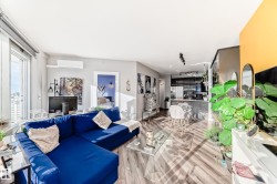 Living room featuring wood finished floors, a wall mounted mini split, and rail lighting - 