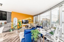 Living area with a baseboard radiator, wood finished floors, and an office area - 