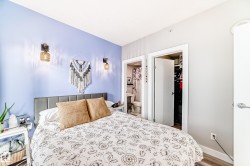 Bedroom with a spacious closet, wood finished floors, and connected bathroom - 