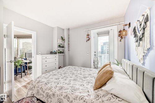 Bedroom with access to outside, light wood finished floors, and radiator heating unit - 2004 10136 104 Street, Edmonton, AB - Indoor Photo Showing Bedroom