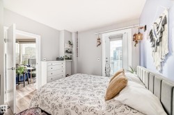 Bedroom with access to outside, light wood finished floors, and radiator heating unit - 